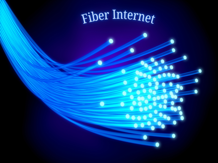 An illustration of fiber optic cables emitting blue light, with the text 