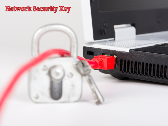 A close-up of a lock and key next to a laptop with a red Ethernet cable plugged in, symbolizing network security.