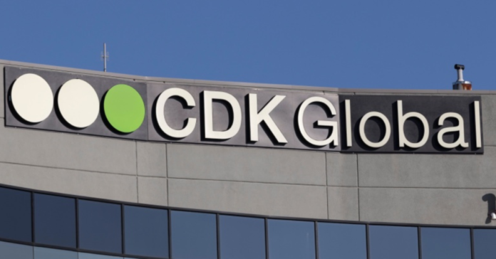 CDK Global logo on the exterior of a corporate office building.